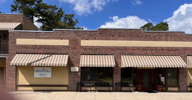 front of Woodbine location with benches and awnings